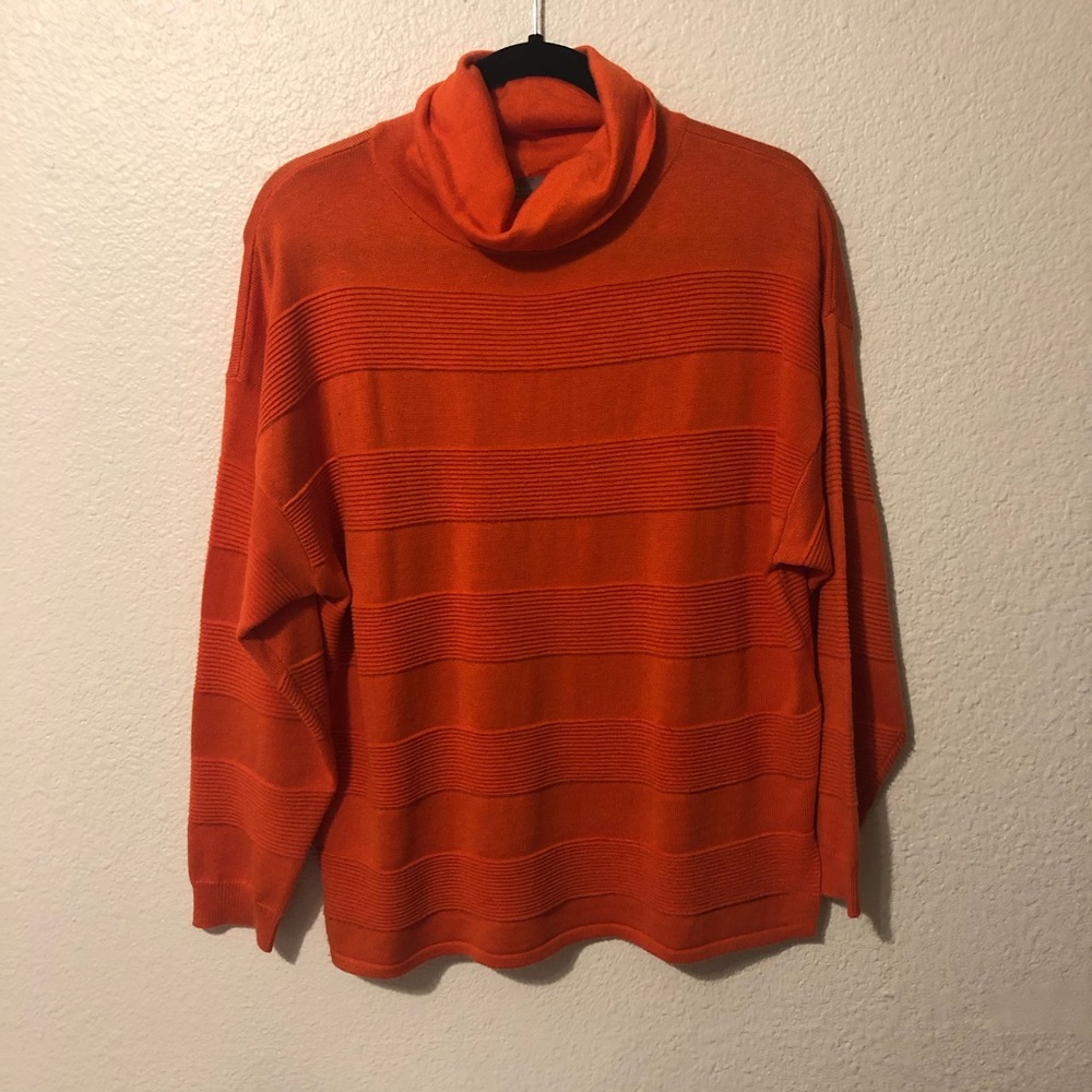 bright orange turtleneck with ruffle stripes